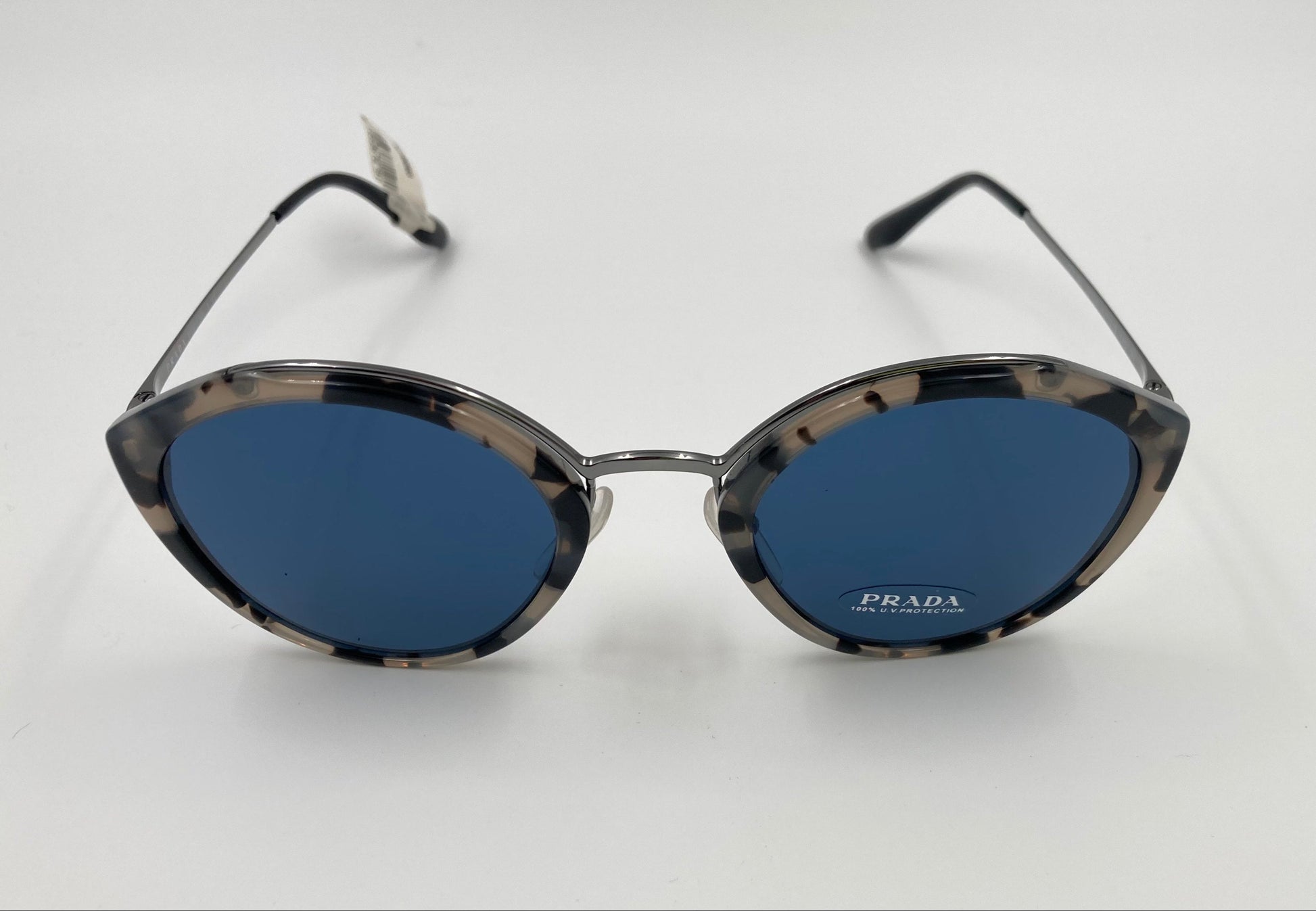 Prada sunglasses with blue lenses on a white background
